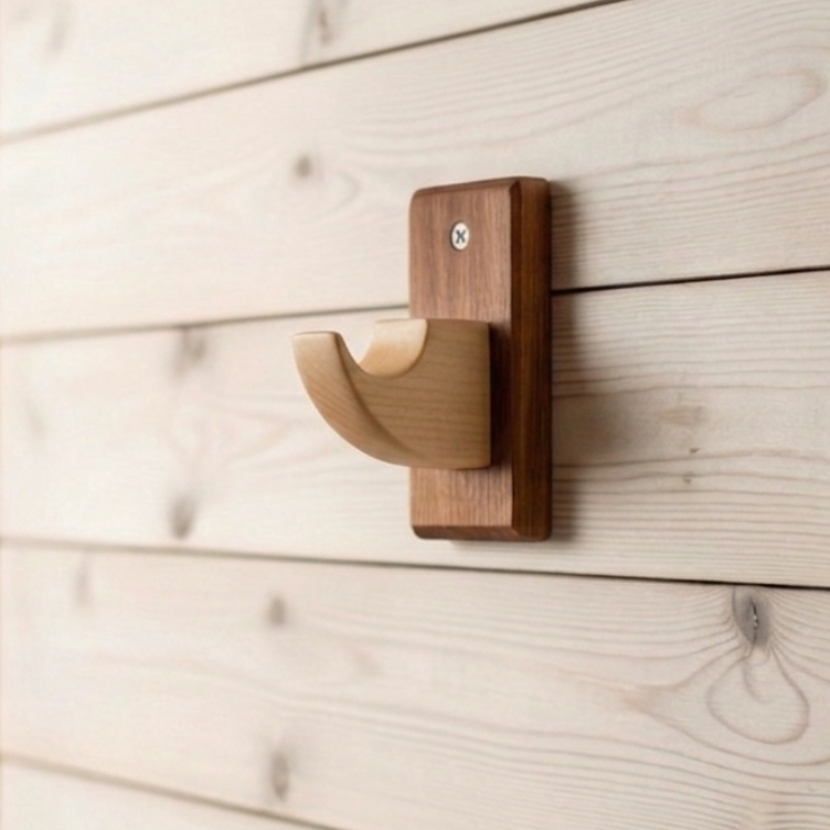 Decorative wall hook on a wooden wall with a blurred background